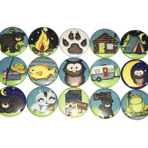 May include: Set of 15 round 1-inch diameter buttons with various camping-themed illustrations. The buttons feature images of a campfire, a bear, an owl, a fish, a tent, a camper, a frog, a squirrel, and a paw print. The buttons are perfect for adding a touch of whimsy to your crafts, clothing, or bags.