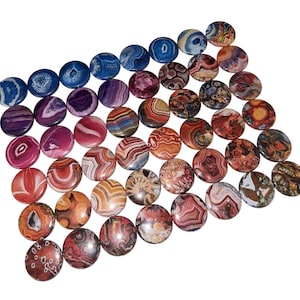 May include: Assortment of round agate slices with colorful patterns in shades of red, orange, yellow, blue, and purple. The agate slices are approximately 1 inch in diameter.