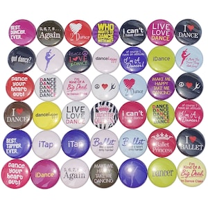 May include: A collection of 25 colorful round buttons with various dance-themed designs and text. The buttons feature phrases like "I Dance", "Dance Your Heart Out", "Live Love Dance", and "Dancing Queen".