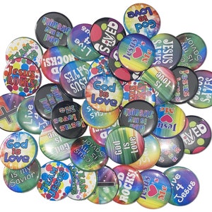 May include: A collection of colorful round buttons with religious messages and designs. The buttons feature phrases like "Jesus Rocks!" and "God is Love" with a variety of colorful backgrounds.