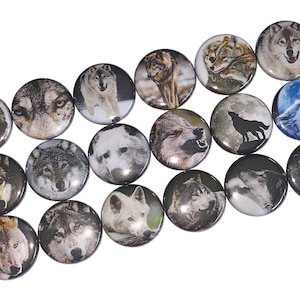 May include: A collection of 16 round button pins featuring various wolf images. The buttons are silver with a glossy finish. The wolf images include black and white, brown and white, and blue and white wolves.