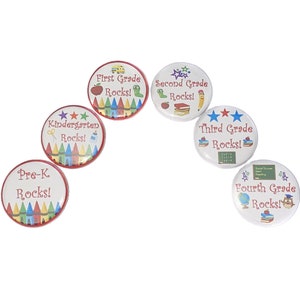 May include: Six round buttons with red borders and white centers. Each button features a different grade level from Pre-K to Fourth Grade with the text "Rocks!" and colorful school-themed graphics.