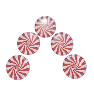 May include: Five red and white peppermint candies arranged in a pyramid shape.