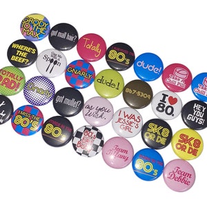 May include: A collection of 20 round 80s themed buttons with various colors, designs, and text. Some of the text includes "Totally Rad", "I Miss the 80s", "Take a Chill Pill", "Sk8 or Die", and "Hey You Guys!"