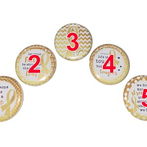 May include: Five gold and white round buttons with a gold ribbon and inspirational text. The buttons are numbered 1 through 5.