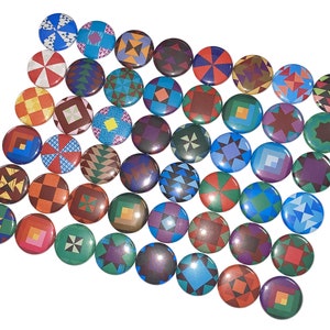 May include: A collection of colorful round buttons with various geometric patterns. The buttons are made of metal and have a shiny finish.