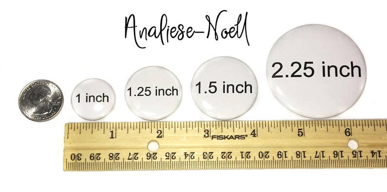 May include: Four white round buttons of different sizes, measuring 1 inch, 1.25 inches, 1.5 inches, and 2.25 inches. The buttons are lined up from smallest to largest on a wooden ruler.