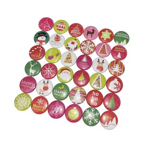 May include: A collection of 25 round Christmas themed buttons with various designs, including snowflakes, reindeer, Santa Claus, Christmas trees, and the words "Merry Christmas", "Happy Holidays", "Ho Ho Ho", and "Noel".