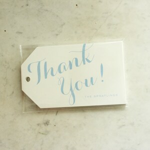 May include: White thank you tag with blue cursive writing that says "Thank You!" and the text "THE SPRATLING'S" in smaller font below.