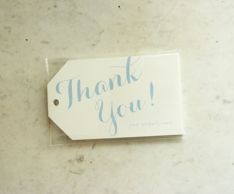 May include: White thank you tag with blue cursive writing that says "Thank You!" and the text "THE SPRATLING'S" in smaller font below.