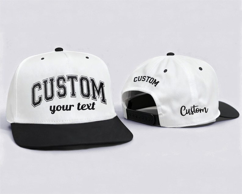 May include: White and black custom baseball cap. The front of the cap features the word "CUSTOM" in a bold, black, collegiate-style font, with "your text" below. The back of the cap has "CUSTOM" printed on it.