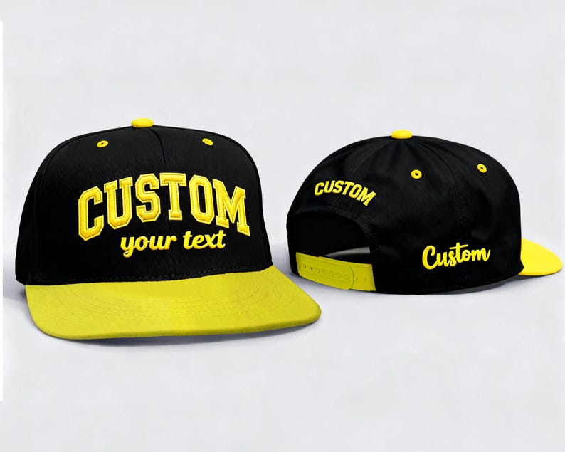 May include: Black and yellow custom snapback hat. The hat features a black crown with the word "CUSTOM" and "your text" in yellow. The brim is yellow, and the hat has a yellow button on top. The back of the hat also has the word "CUSTOM" in yellow.