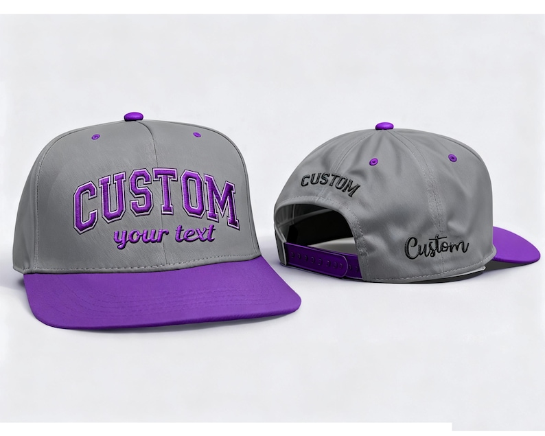 May include: A gray baseball cap with a purple brim and a purple button on top. The word "CUSTOM" is embroidered in purple on the front, with "your text" below it. The back of the cap also has the word "CUSTOM" embroidered.