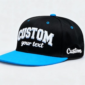 May include: Black and blue custom baseball cap with the word "CUSTOM" in white, bold, 3D lettering. The text "your text" is below the word "CUSTOM". The brim is bright blue, and the cap has a blue button on top.