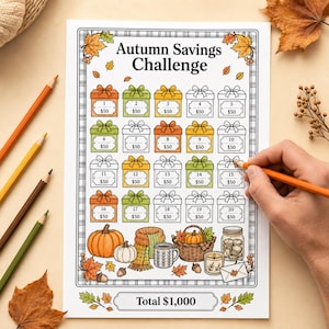 May include: A printed Autumn Savings Challenge tracker sheet featuring twenty gift box icons labeled with numbers 1 through 20 and $50, surrounded by fall-themed illustrations including pumpkins, a basket, a scarf, and leaves.