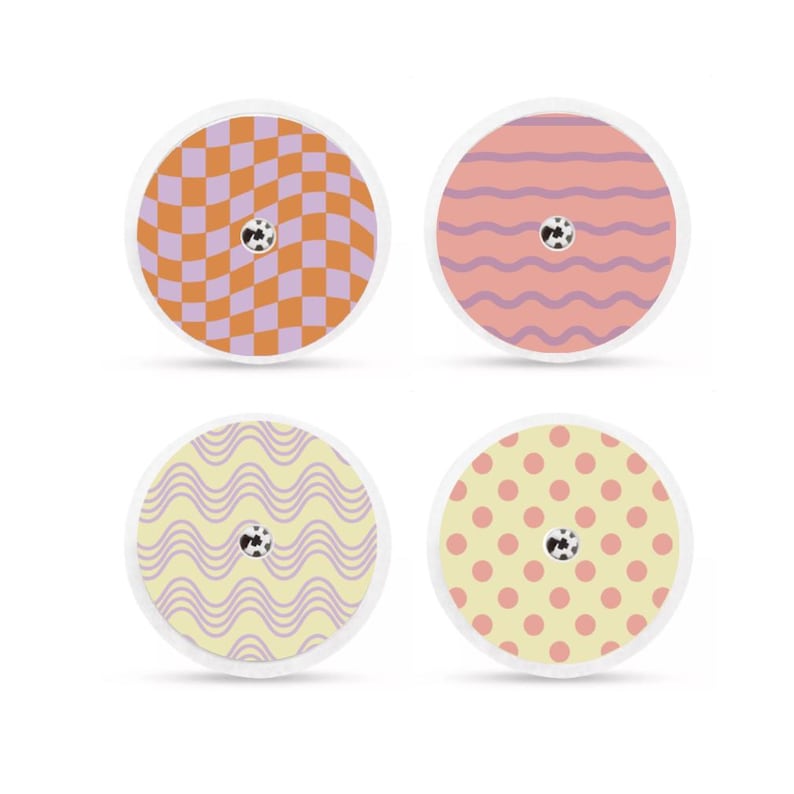 May include: Four circular adhesive patches with decorative patterns. One has an orange and purple checkerboard design, another has pink and purple wavy lines, a third has yellow and purple wavy lines, and the last has yellow polka dots.