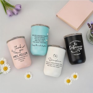 May include: Four stainless steel tumblers in pastel pink, light blue, white, and black. Each features black text: 'Thank you MRS. MILLER OUR WONDERFUL TEACHER 2025', 'NEVER UNDERESTIMATE THE DIFFERENCE YOU HAVE MADE', 'Discipline', and 'NEVER FORGET THE DIFFERENCE YOU MAKE'.