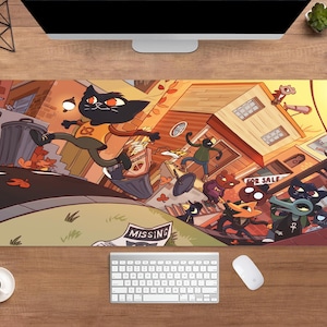 May include: A rectangular desk mat with a vibrant cartoon illustration of animal characters in a town. The design includes a black cat running, buildings, and the word "MISSING". A keyboard, mouse, and a coffee cup are also visible.