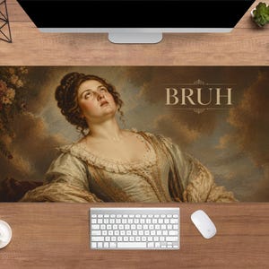 May include: A rectangular desk mat with a classical painting of a woman looking upwards, and the word "BRUH". The mat has a brown background. Computer accessories, including a keyboard and mouse, surround the mat.