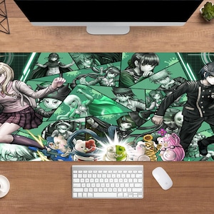 May include: A large rectangular mouse mat featuring a collage of anime characters in a green and white geometric design. The characters are in various action poses. A keyboard and mouse are visible below the mat.