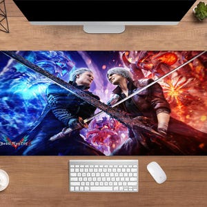 May include: A rectangular mouse mat with a vibrant illustration of two figures clashing with swords. The artwork is predominantly blue and red, with the text "Devil May Cry" at the bottom. The mat is designed for computer use.