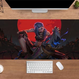 May include: A rectangular desk mat with a striking illustration of a female character with blue hair and a mechanical creature set against a red moon. The artwork uses dark tones and dynamic poses, ideal for gamers.