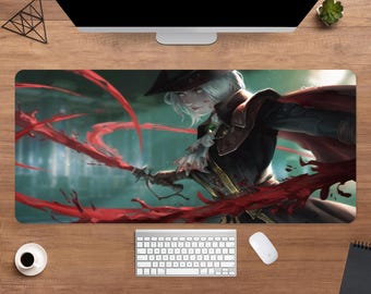 May include: A rectangular mouse pad featuring a fantasy illustration of a character with white hair, wearing a black hat and coat, wielding a sword with red energy. The background is a blurred green and blue.