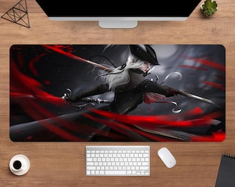 May include: A rectangular mouse pad featuring a digital illustration of a character with white hair, wearing a black hat and coat, holding two swords. The background is dark with red streaks. A keyboard, mouse, and coffee cup are visible.