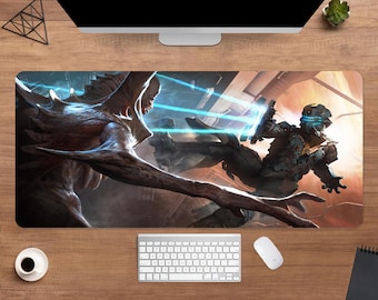 May include: A rectangular gaming mouse pad featuring a sci-fi battle scene with a creature and a space suit character. The pad has a black border and is designed for computer use.