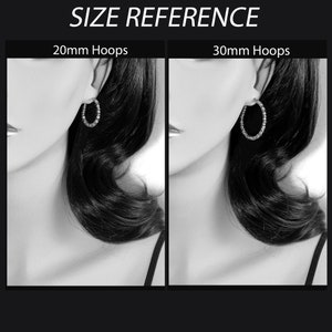 May include: A side-by-side comparison of two hoop earrings, one measuring 20mm and the other 30mm. The earrings are silver and have a simple, classic design.