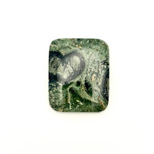 May include: A rectangular polished gemstone cabochon featuring a marbled pattern of deep forest green, dark charcoal, and lighter sage green tones with a smooth, glossy surface and rounded corners, displaying natural mineral inclusions throughout.