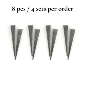 May include: Eight grey metal triangle-shaped objects arranged in pairs on a white background. The text "8 pcs / 4 sets per order" is at the top of the image.