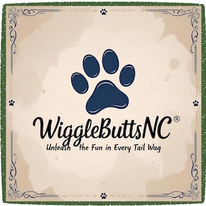 May include: A vintage-style graphic with a dark blue paw print at the top. The text "WiggleButtsNC" is in a cursive font, with the tagline "Unleash the Fun in Every Tail Wag" below. The background is beige with a green border.