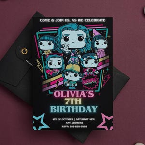 May include: Black invitation card with a colorful graphic featuring cartoon characters. The text reads "Olivia's 7th Birthday" with the date, time, and RSVP information. The card is set against a dark background with a matching envelope.