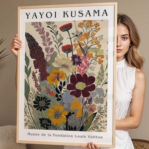May include: A framed art print featuring a floral illustration by Yayoi Kusama. The print displays a variety of colorful flowers in shades of yellow, red, purple, and green against a cream background, with the text YAYOI KUSAMA and Musée de la Fondation Louis Vuitton.
