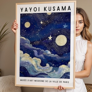 May include: A rectangular framed art print featuring the text YAYOI KUSAMA at the top and MUSÉE D'ART MODERNE DE LA VILLE DE PARIS at the bottom. The artwork depicts a dark blue night sky with swirling patterns, a large moon, stars, and clouds.