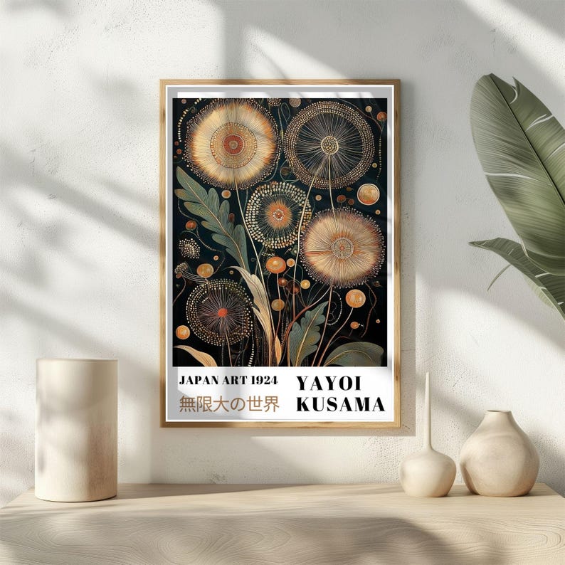 May include: A framed art print featuring a botanical illustration of stylized dandelions in shades of gold, orange, and green against a dark background. The print includes the text "JAPAN ART 1924" and "YAYOI KUSAMA".