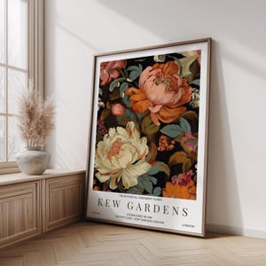 May include: Framed floral print featuring large, colorful peonies in shades of peach, orange, and cream against a dark background. The print includes the text "KEW GARDENS" and "LONDON". The botanical theme is evident in the detailed flower illustrations.