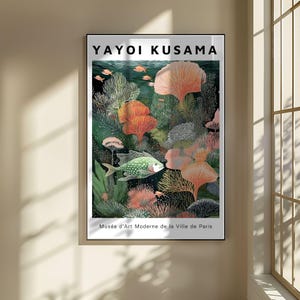 May include: A framed art print featuring a colorful underwater scene. The artwork, by Yayoi Kusama, depicts coral, fish, and other marine life in shades of green, orange, and pink. The text "Mus&eacute;e d'Art Moderne de la Ville de Paris" is at the bottom.