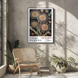 May include: A framed art print featuring a Yayoi Kusama artwork with a black background and stylized floral shapes in shades of beige, orange, and yellow. The print includes the artist's name and the city of Tokyo.
