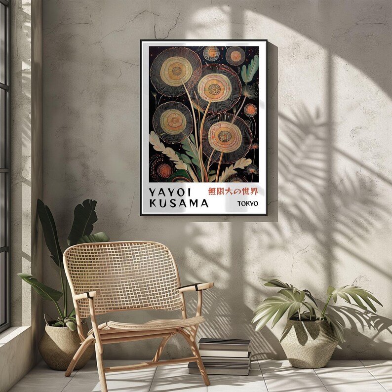 May include: A framed art print featuring a Yayoi Kusama artwork with a black background and stylized floral shapes in shades of beige, orange, and yellow. The print includes the artist's name and the city of Tokyo.