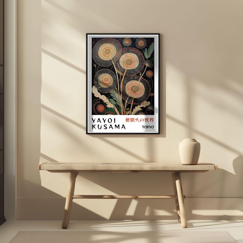 May include: A framed art print featuring a Yayoi Kusama artwork. The print showcases a stylized floral design in shades of yellow, orange, and green against a dark background. The artist's name and the city, Tokyo, are displayed at the bottom.