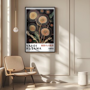 May include: A framed art print featuring a floral design with a black background. The artwork includes circular flower shapes in shades of yellow and gold, with green foliage. The print has text that reads "YAYOI KUSAMA 無限大の世界 TOKYO".