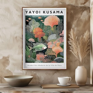 May include: A framed art print featuring a vibrant underwater scene with coral and fish. The artwork, by Yayoi Kusama, includes the text "Mus&eacute;e d'Art Moderne de la Ville de Paris". The color palette includes shades of green, orange, and blue.