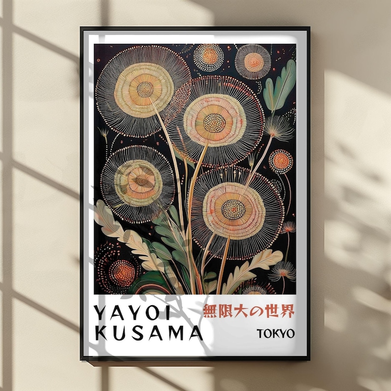 May include: A framed art print featuring a floral design with circular, textured blooms in shades of beige, orange, and yellow against a dark background. The print includes the artist's name, "YAYOI KUSAMA," and the city "TOKYO."