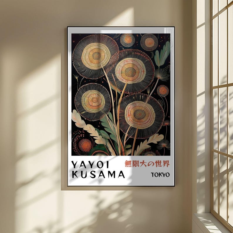 May include: A framed art print featuring a floral design with circular shapes in shades of yellow, orange, and brown against a black background. The print includes the text "YAYOI KUSAMA" and Japanese characters, with "TOKYO" below.