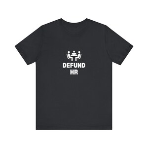 May include: Black t-shirt with a white graphic of a group of people sitting around a table and the text "DEFUND HR".
