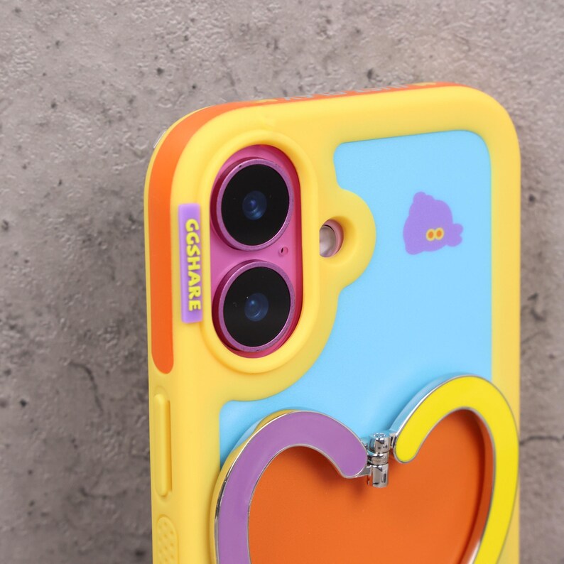 May include: A yellow and blue phone case with a heart-shaped stand. The case has a purple and orange heart-shaped stand. The case has the text "GGSHARE" on the side. A cartoon purple figure with the number 8 is on the blue background.
