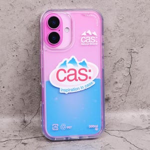 May include: A clear phone case with a pink and blue design. The case features the text "cas: Natural Mineral" and "inspiration in case." The case is designed for a phone with two camera lenses and has a 500ml capacity.