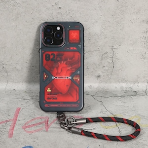 May include: A dark grey phone case featuring a red graphic of a human heart and biohazard symbols. The case has a black and red wrist strap attached. The text "02" and "100°CASE" are visible on the case.